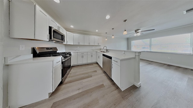 1835 Nevada Ave NE, Saint Petersburg, FL 33703 - kitchen with ceiling fan, a peninsula, visible vents, a sink, and stainless steel appliances