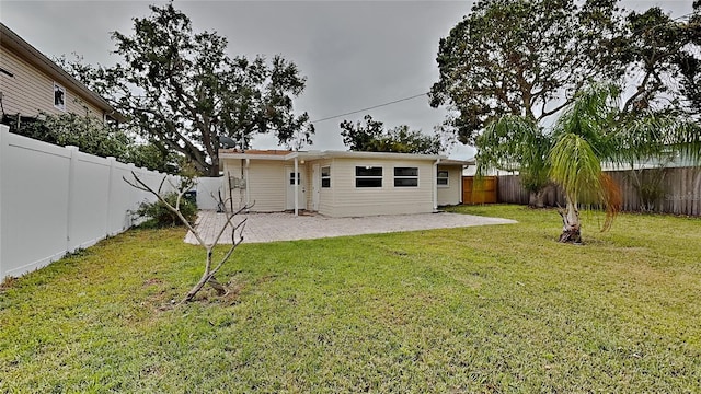 1835 Nevada Ave NE, Saint Petersburg, FL 33703 - back of property featuring a yard, a fenced backyard, and a patio