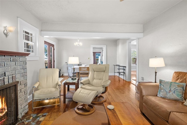 3120 8th Ave N, Saint Petersburg, FL 33713 - living area featuring a fireplace, wood finished floors, and plenty of natural light