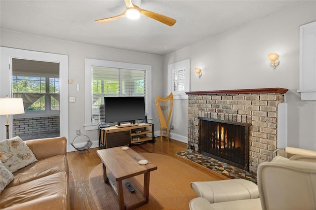 3120 8th Ave N, Saint Petersburg, FL 33713 - living area with wood finished floors, a ceiling fan, a fireplace, and baseboards