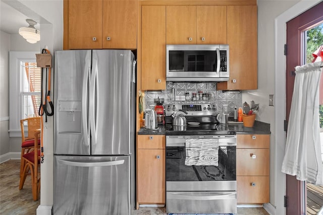 3120 8th Ave N, Saint Petersburg, FL 33713 - kitchen with appliances with stainless steel finishes, decorative backsplash, and baseboards