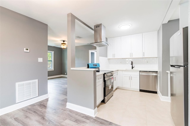 2017 Oceanview Pl, Tampa, FL 33605 - kitchen with visible vents, light countertops, ventilation hood, a sink, and appliances with stainless steel finishes