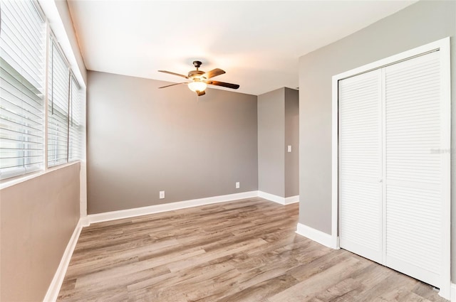 2017 Oceanview Pl, Tampa, FL 33605 - unfurnished bedroom featuring baseboards, ceiling fan, a closet, and light wood-type flooring