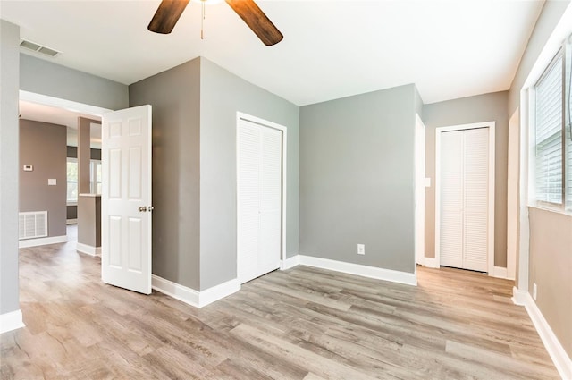 2017 Oceanview Pl, Tampa, FL 33605 - unfurnished bedroom with two closets, light wood-type flooring, and visible vents