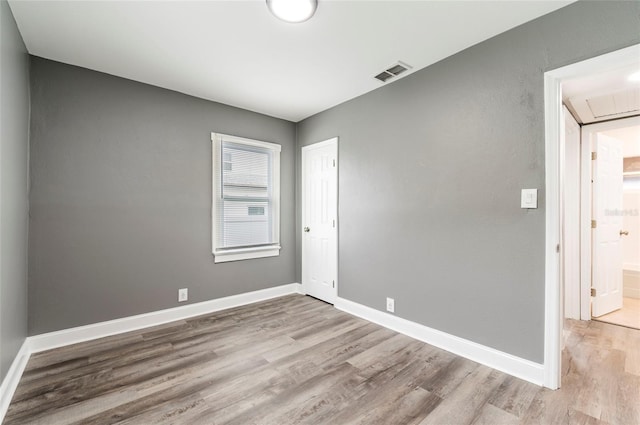 2017 Oceanview Pl, Tampa, FL 33605 - spare room featuring visible vents, attic access, baseboards, and wood finished floors