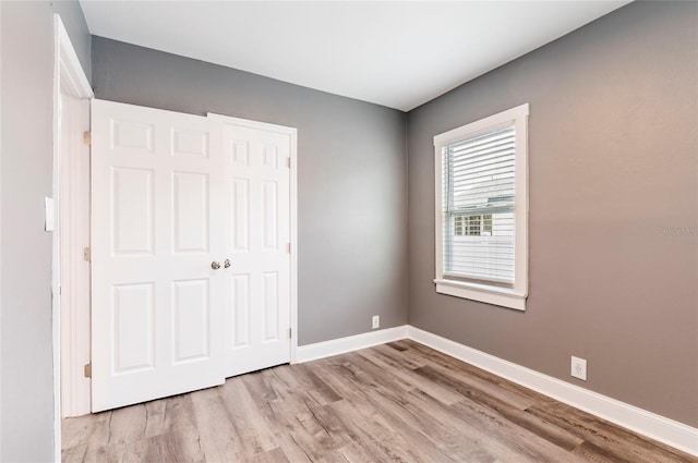 2017 Oceanview Pl, Tampa, FL 33605 - unfurnished bedroom featuring baseboards and wood finished floors