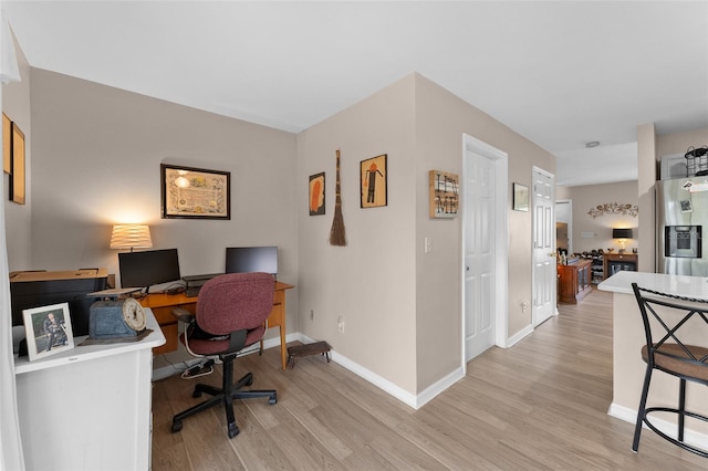 office featuring light wood-style floors and baseboards