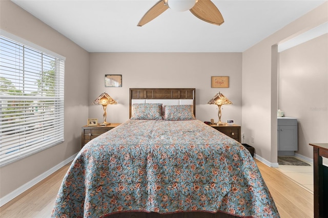 bedroom with light wood-style flooring, baseboards, and a ceiling fan