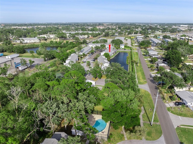 aerial view of property and surrounding area with a nearby body of water and nearby suburban area