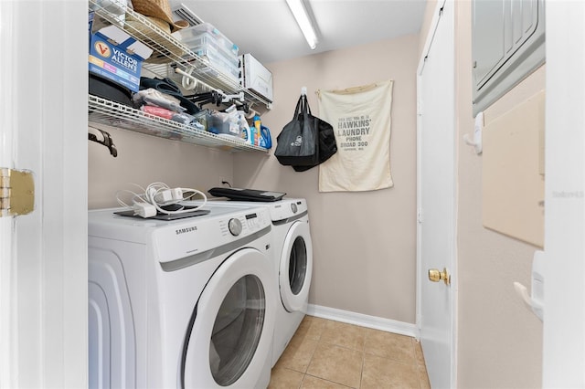 laundry area with independent washer and dryer, baseboards, and light tile patterned floors