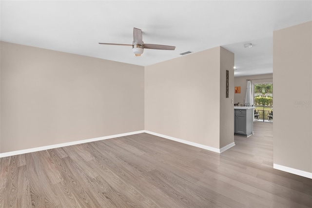 5503 67th Ave N Unit 18, Pinellas Park, FL 33781 - unfurnished room featuring a ceiling fan, light wood-style flooring, baseboards, and a smoke detector