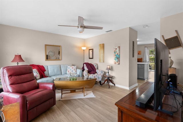 5503 67th Ave N Unit 18, Pinellas Park, FL 33781 - living area with ceiling fan, light wood finished floors, and baseboards