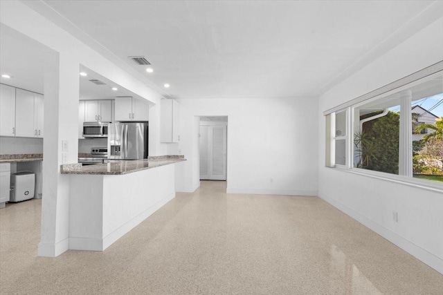 2540 S Shore Dr SE, Saint Petersburg, FL 33705 - kitchen with stone counters, stainless steel appliances, recessed lighting, and baseboards