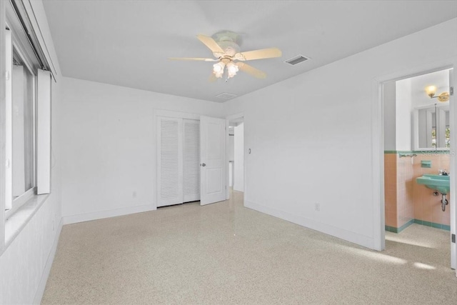 2540 S Shore Dr SE, Saint Petersburg, FL 33705 - unfurnished bedroom featuring baseboards, visible vents, ensuite bathroom, and a closet