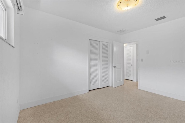 2540 S Shore Dr SE, Saint Petersburg, FL 33705 - unfurnished bedroom with a closet, visible vents, speckled floor, and baseboards