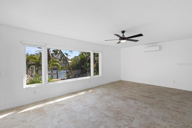 2540 S Shore Dr SE, Saint Petersburg, FL 33705 - spare room with a wall mounted air conditioner, ceiling fan, plenty of natural light, and baseboards