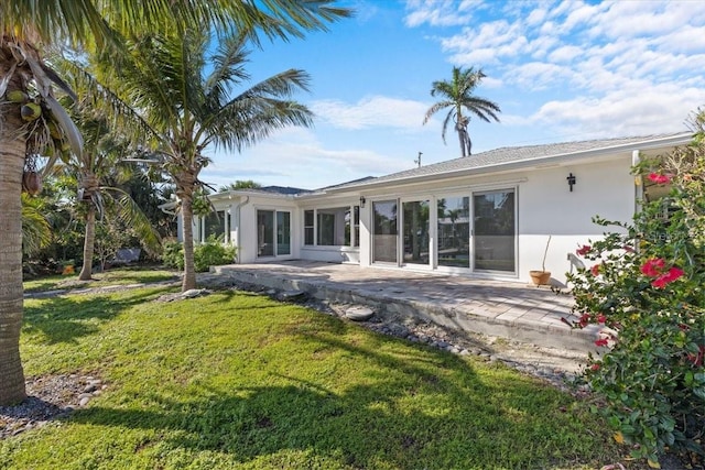 2540 S Shore Dr SE, Saint Petersburg, FL 33705 - rear view of house featuring a patio, a yard, and stucco siding
