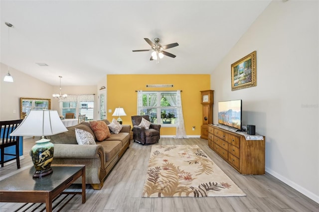 2720 N Screech Owl Ave, Saint Augustine, FL 32084 - living room featuring light wood-style flooring, a ceiling fan, a chandelier, lofted ceiling, and baseboards