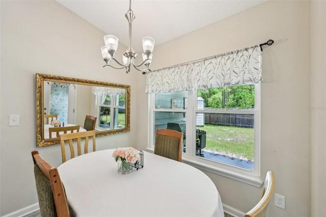 2720 N Screech Owl Ave, Saint Augustine, FL 32084 - dining room with baseboards, healthy amount of natural light, and a chandelier