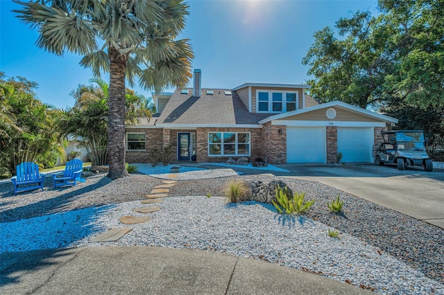 508 N Mayo St, Crystal Beach, FL 34681 - view of front of house with brick siding, a garage, a chimney, and concrete driveway