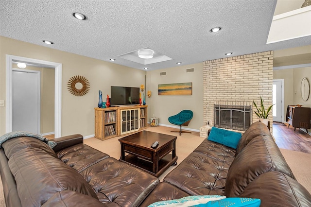 508 N Mayo St, Crystal Beach, FL 34681 - living area featuring baseboards, a fireplace, a textured ceiling, and visible vents
