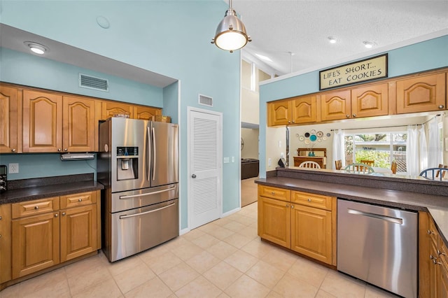 508 N Mayo St, Crystal Beach, FL 34681 - kitchen with visible vents, dark countertops, high vaulted ceiling, brown cabinets, and appliances with stainless steel finishes
