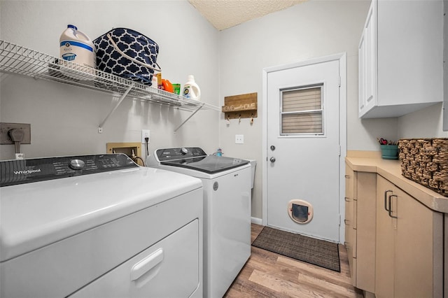 508 N Mayo St, Crystal Beach, FL 34681 - laundry room with separate washer and dryer, light wood finished floors, and cabinet space
