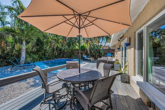508 N Mayo St, Crystal Beach, FL 34681 - wooden deck with a fenced backyard, an outdoor hangout area, a fenced in pool, and outdoor dining area