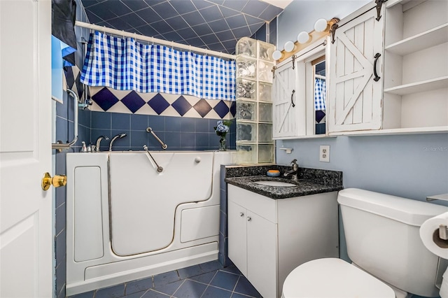 bathroom with toilet, tile patterned floors, vanity, and a shower with shower curtain
