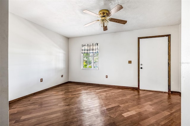 spare room with ceiling fan, baseboards, and wood finished floors