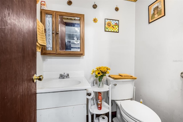 half bathroom featuring toilet and vanity