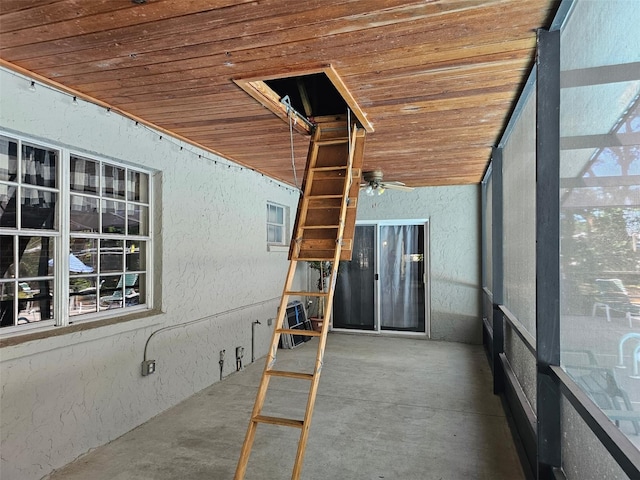 unfurnished sunroom with a ceiling fan