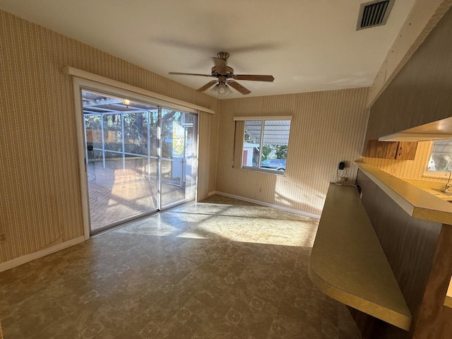 doorway to outside featuring visible vents, baseboards, ceiling fan, wallpapered walls, and tile patterned floors