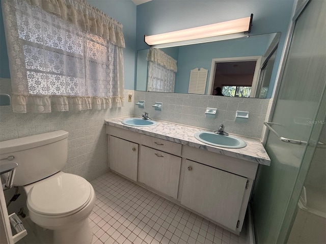 bathroom featuring a sink, tile patterned floors, and toilet