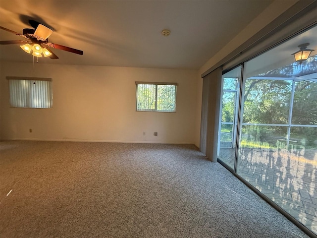 carpeted empty room featuring a ceiling fan