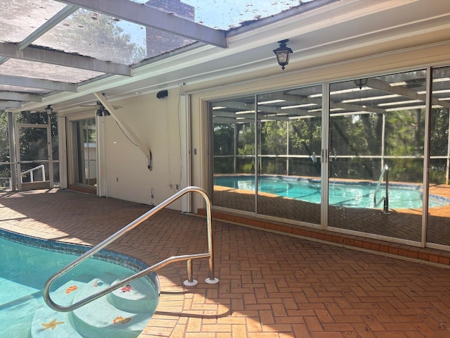 pool with a lanai and a patio area