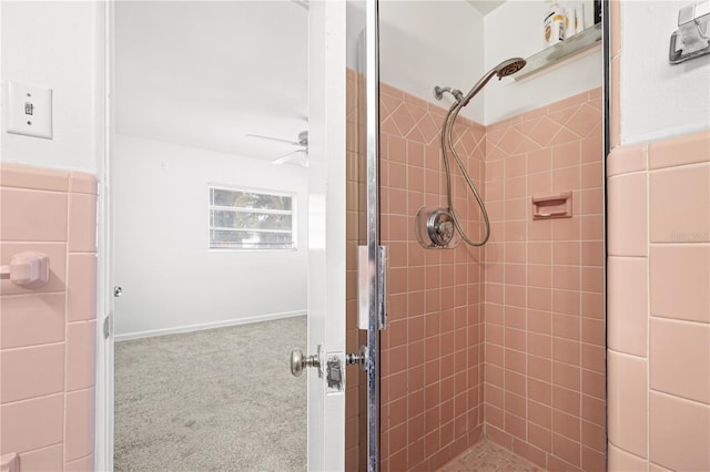 full bathroom featuring ceiling fan and tiled shower