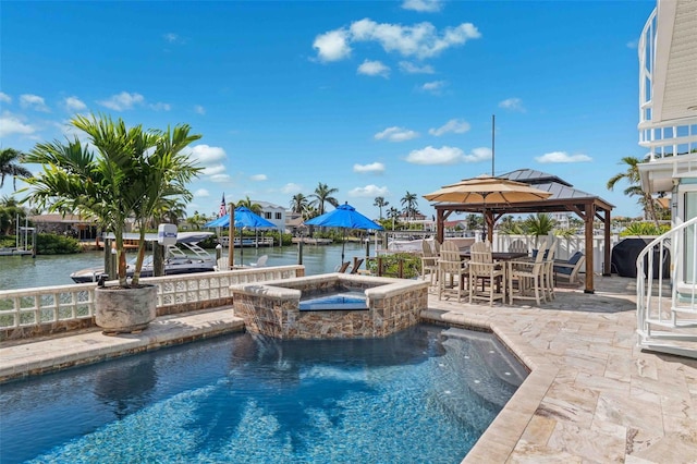 view of swimming pool featuring a gazebo, a fenced in pool, a water view, an in ground hot tub, and a patio area