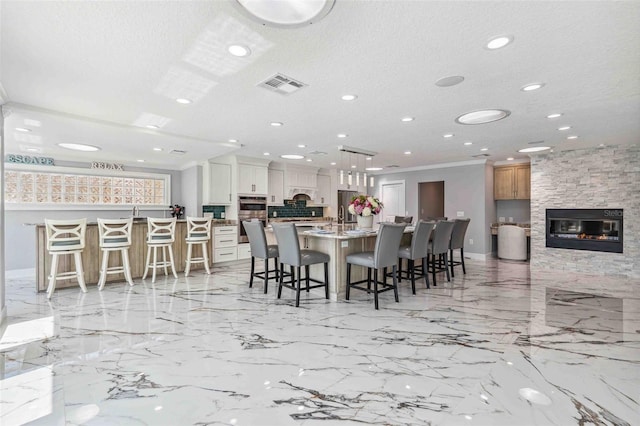 dining room featuring visible vents, baseboards, a stone fireplace, recessed lighting, and a textured ceiling