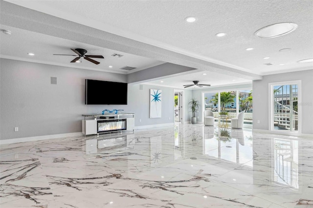living area with crown molding, visible vents, baseboards, a textured ceiling, and a ceiling fan