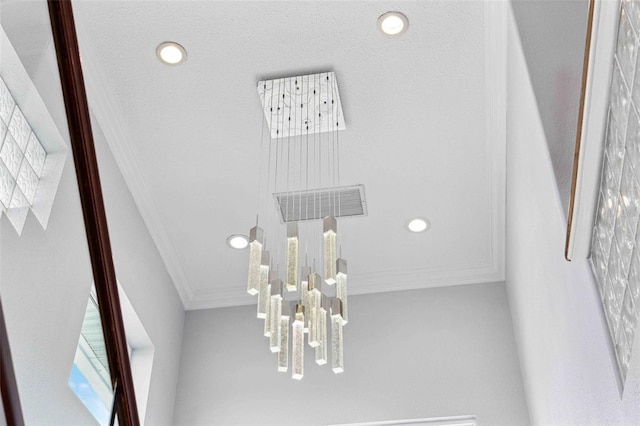 details featuring recessed lighting, ornamental molding, and a notable chandelier