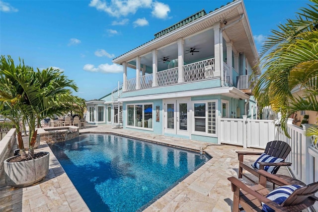 rear view of house featuring french doors, a ceiling fan, a patio area, a balcony, and a fenced backyard