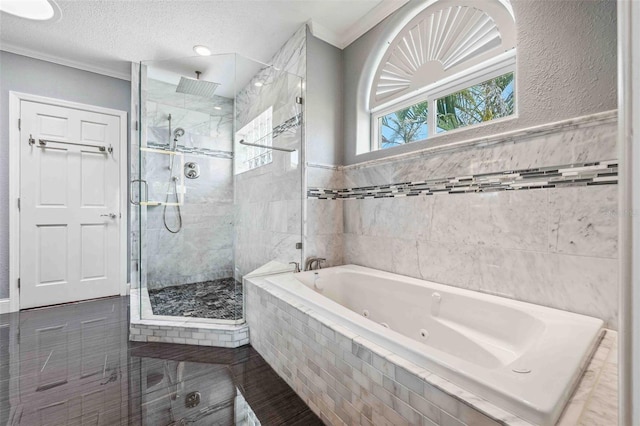 bathroom with a whirlpool tub, tile walls, a shower stall, and ornamental molding