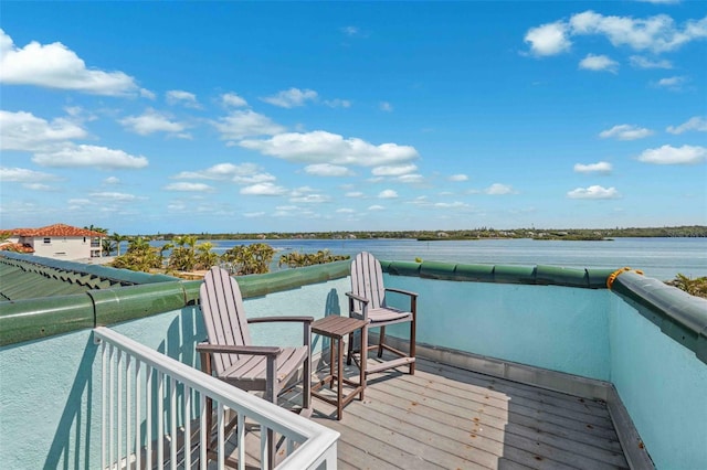dock area with a water view and a balcony