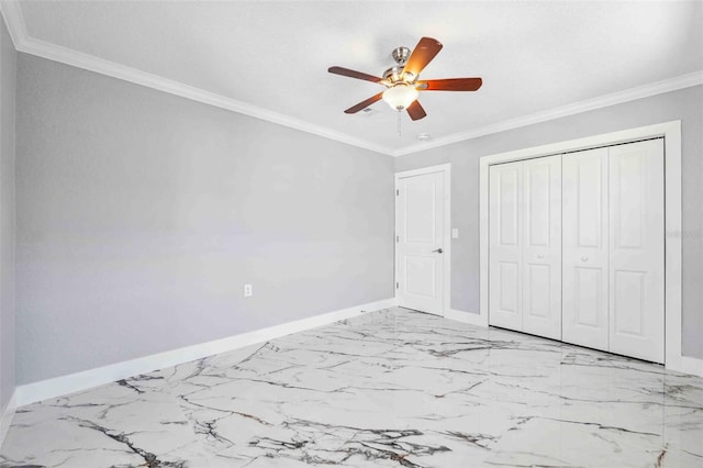 unfurnished bedroom featuring baseboards, marble finish floor, crown molding, and a closet