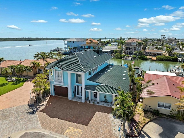 drone / aerial view with a water view and a residential view