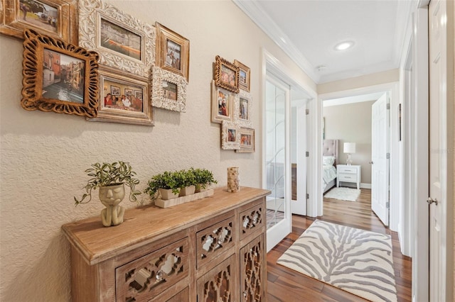 hall featuring dark wood-type flooring, french doors, crown molding, and recessed lighting