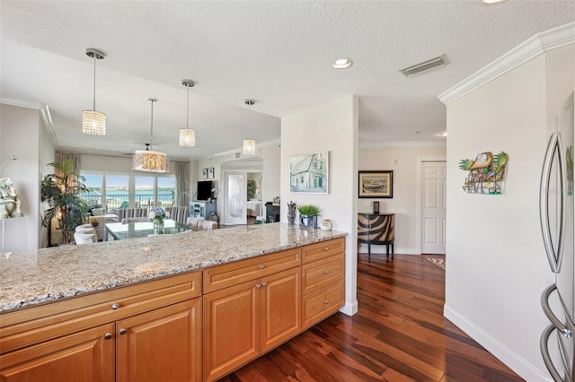 kitchen featuring dark wood-style floors, baseboards, light stone countertops, and crown molding