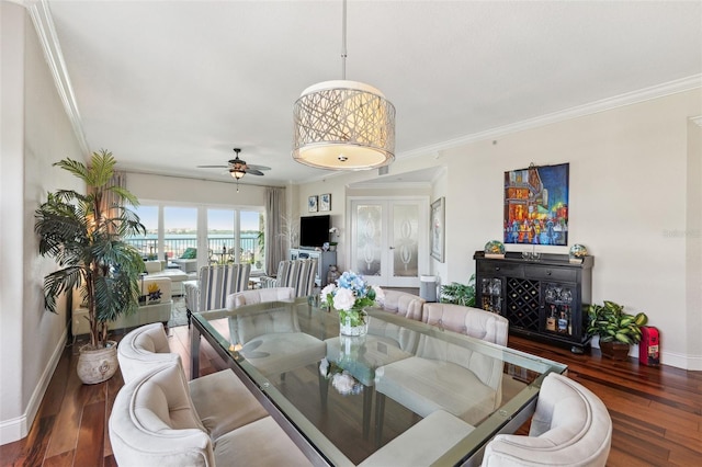 dining area with crown molding, ceiling fan, wood finished floors, and baseboards