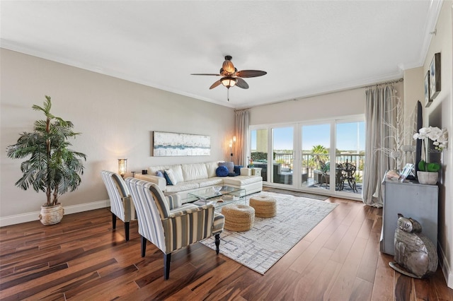 living room with baseboards, wood finished floors, ceiling fan, and crown molding